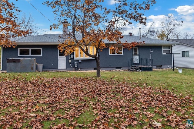 64 Hays Crk, Silver Bay, MN 55614 - back of house featuring a shingled roof, a chimney, and a yard