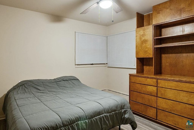 64 Hays Crk, Silver Bay, MN 55614 - bedroom with baseboard heating, ceiling fan, and light wood-type flooring