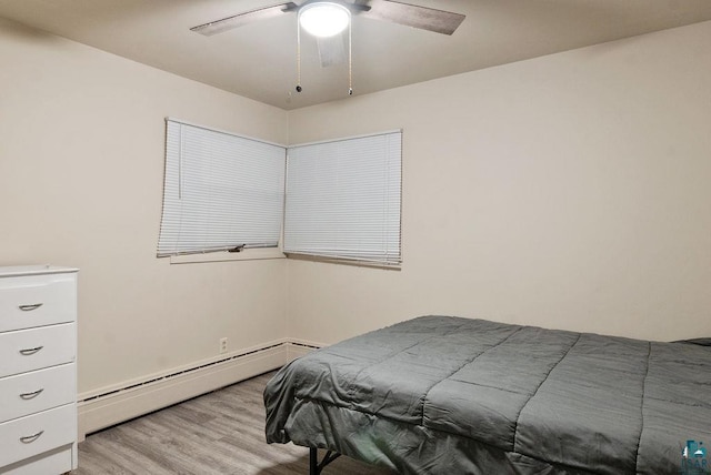 64 Hays Crk, Silver Bay, MN 55614 - bedroom with a baseboard radiator, ceiling fan, and light wood-type flooring