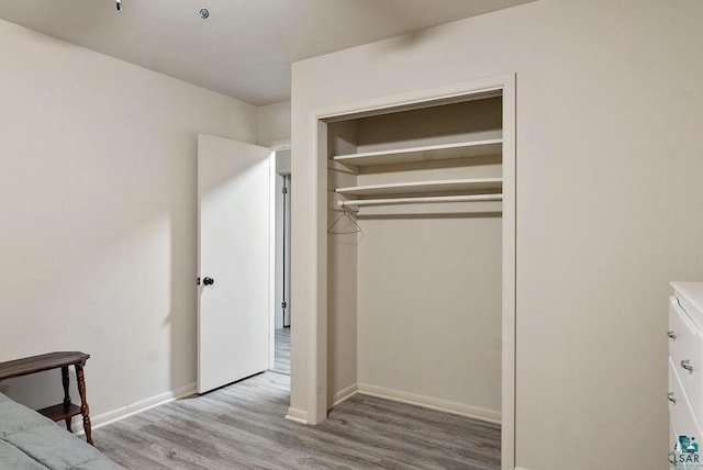 64 Hays Crk, Silver Bay, MN 55614 - unfurnished bedroom with baseboards, wood finished floors, and a closet