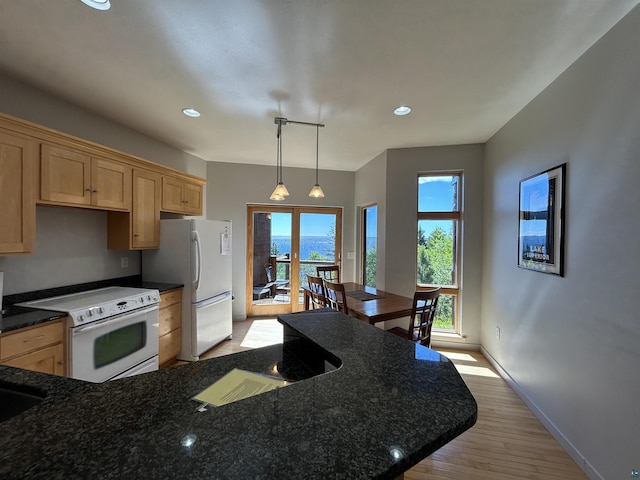 kitchen with light brown cabinetry, white appliances, light wood-style flooring, baseboards, and recessed lighting