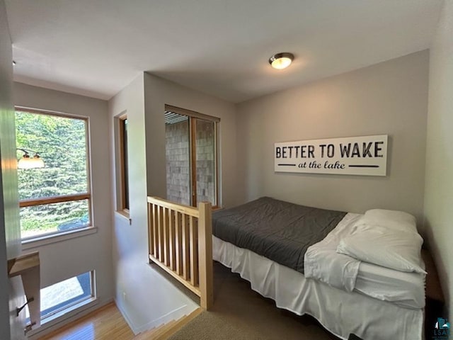 bedroom featuring wood finished floors and baseboards
