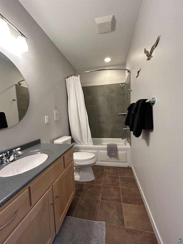bathroom featuring tile patterned flooring, toilet, vanity, baseboards, and shower / tub combo