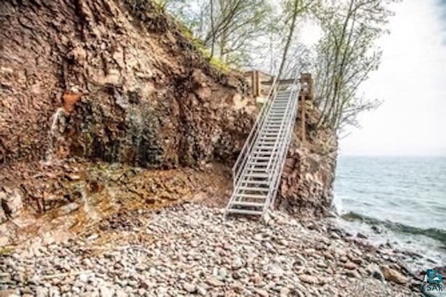 exterior space featuring stairway and a water view
