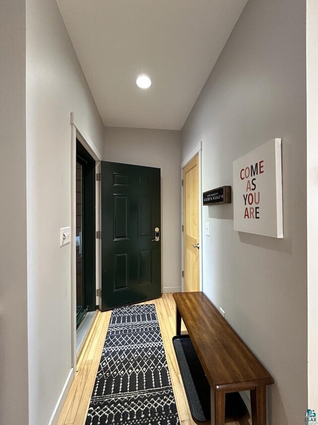 doorway to outside with baseboards, light wood finished floors, and recessed lighting