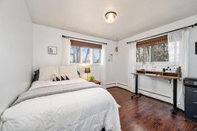 bedroom with a baseboard heating unit, a baseboard radiator, and dark wood finished floors