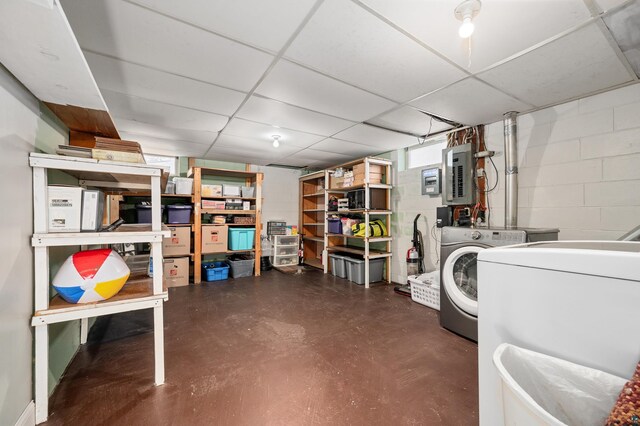 washroom featuring washer / dryer, concrete block wall, electric panel, and laundry area