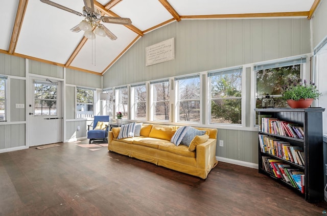 sunroom with ceiling fan, wood finished floors, and lofted ceiling with beams