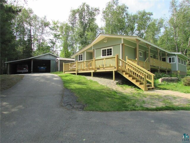view of front of home with a porch, a carport, and aphalt driveway