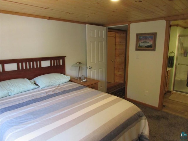 carpeted bedroom featuring baseboards and wood ceiling