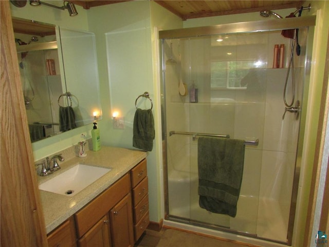 full bathroom with a shower stall and vanity