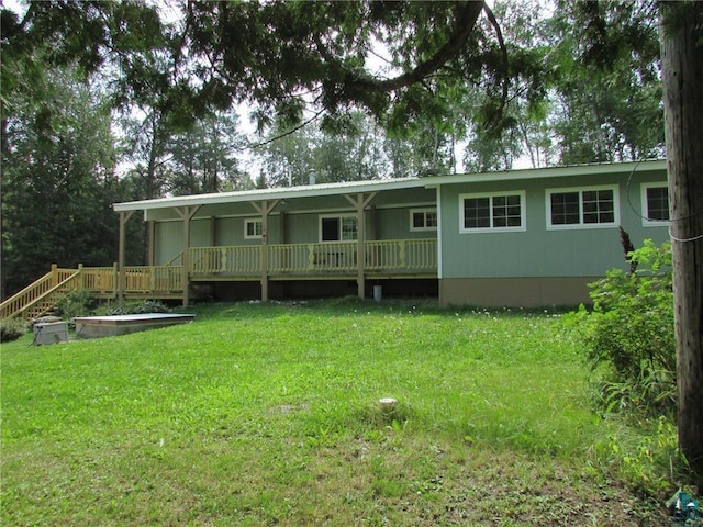 back of house featuring a porch and a yard