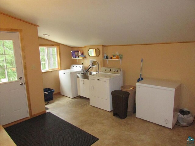 laundry room with a sink, laundry area, and washing machine and dryer
