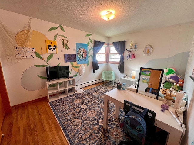 office area with a textured ceiling, wood finished floors, baseboards, and a baseboard radiator
