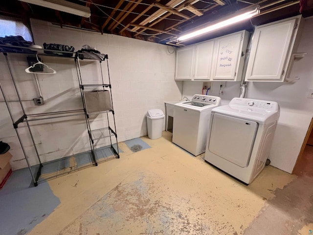 washroom with independent washer and dryer and cabinet space
