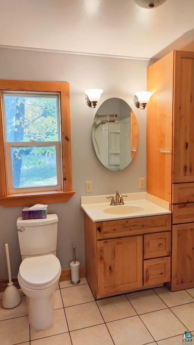 bathroom with tile patterned floors, vanity, toilet, and baseboards