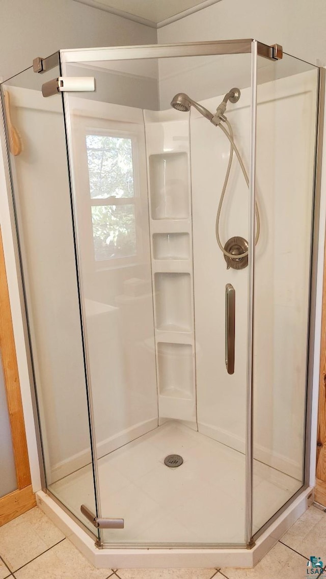 full bathroom featuring a stall shower and tile patterned floors