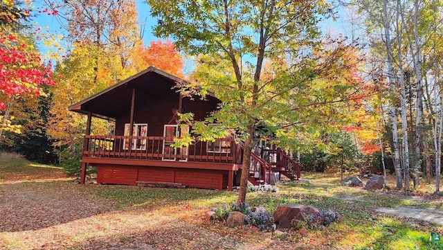 exterior space featuring a wooden deck and stairway
