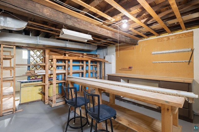 unfinished basement featuring a workshop area