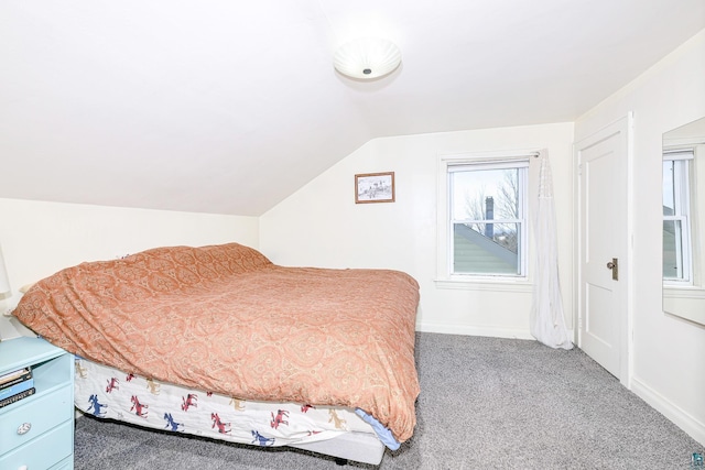 carpeted bedroom featuring baseboards and lofted ceiling
