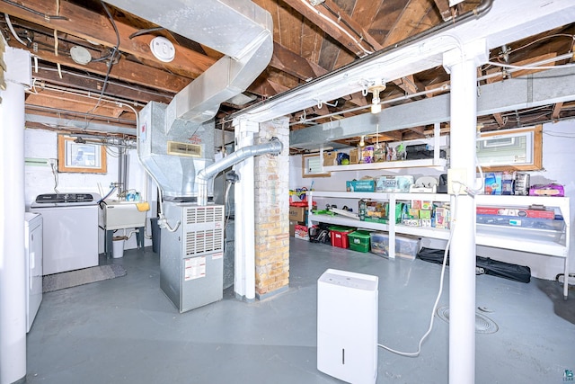 unfinished below grade area featuring heating unit and washer and clothes dryer