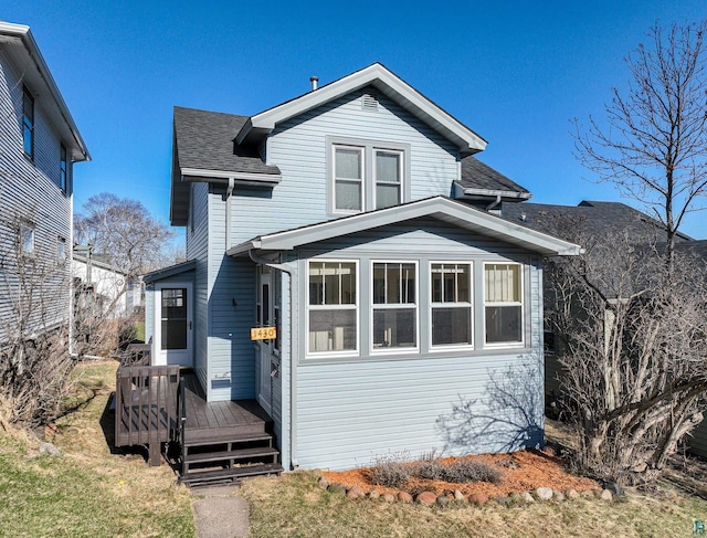 view of front of house with a wooden deck and a shingled roof