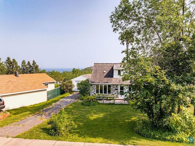 view of front of property with fence and a front lawn