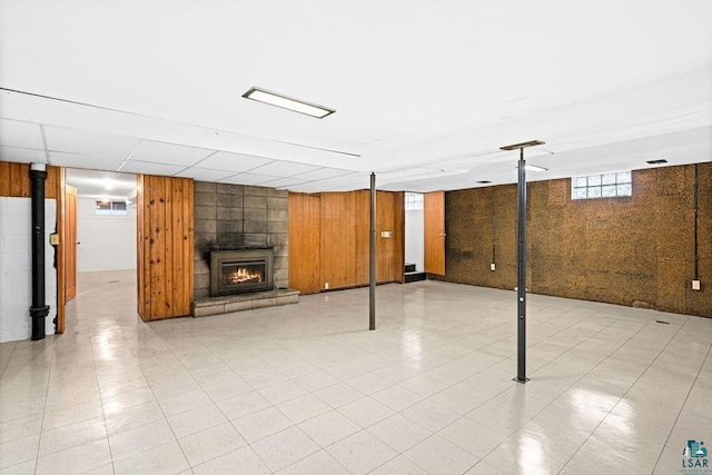 below grade area with wood walls and a large fireplace