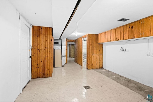 hallway with wooden walls and visible vents