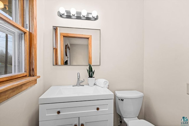 bathroom with toilet and vanity