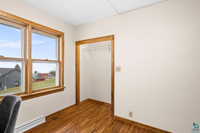 office area with baseboards, a baseboard heating unit, and wood finished floors