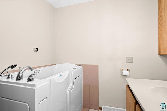 laundry area featuring visible vents and a sink