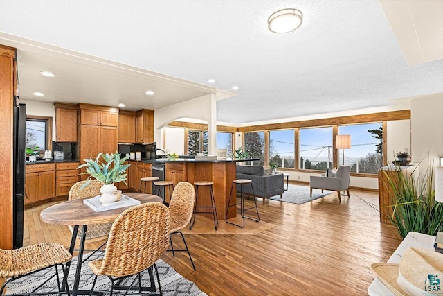 dining space featuring recessed lighting and light wood-type flooring