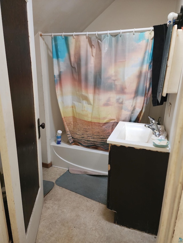 bathroom with shower / bathtub combination with curtain, vaulted ceiling, and vanity