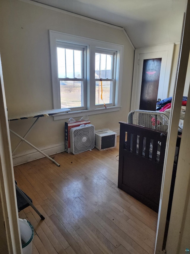bedroom featuring hardwood / wood-style flooring and lofted ceiling