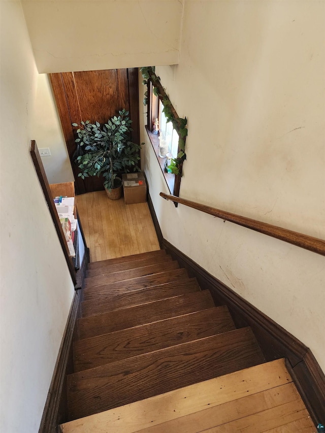 stairway with wood finished floors