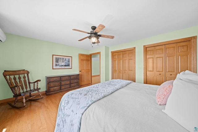 bedroom featuring ceiling fan, light wood-style floors, multiple closets, and baseboards