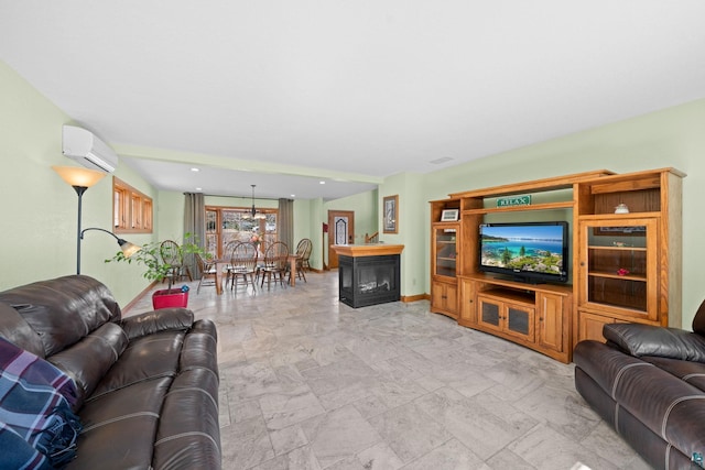 living room with a wall unit AC and baseboards
