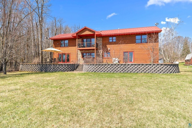 rear view of property with stairway, a yard, a wooden deck, and metal roof