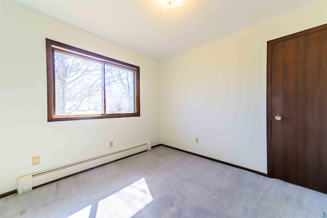 unfurnished room with carpet flooring and baseboard heating