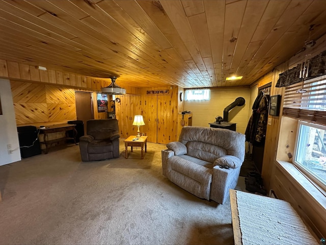 3824 Rehbein Rd, Duluth, MN 55803 - carpeted living area featuring a wood stove, wood ceiling, and wooden walls