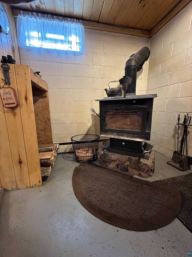 3824 Rehbein Rd, Duluth, MN 55803 - room details with concrete block wall and a wood stove