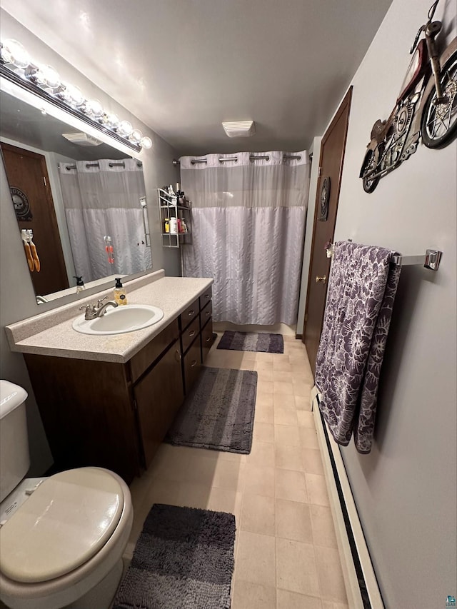 3824 Rehbein Rd, Duluth, MN 55803 - bathroom with vanity, toilet, a shower with shower curtain, and a baseboard radiator