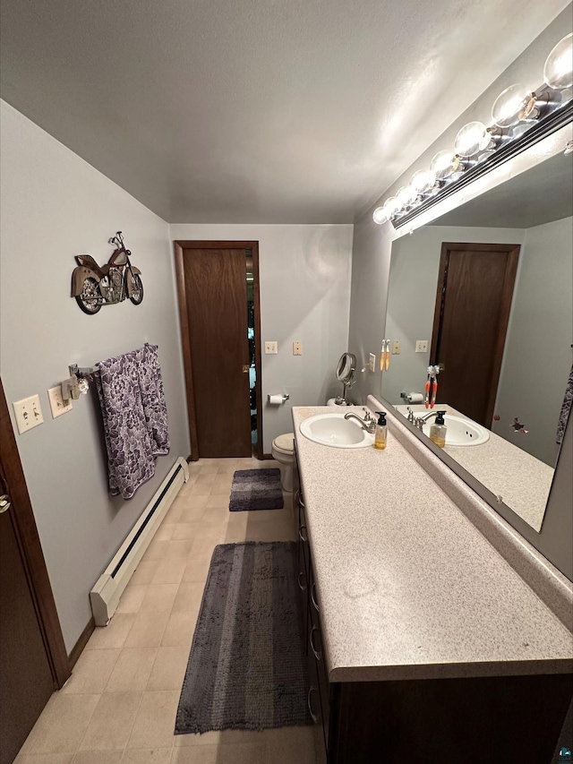 3824 Rehbein Rd, Duluth, MN 55803 - bathroom featuring vanity, tile patterned floors, a baseboard heating unit, and toilet