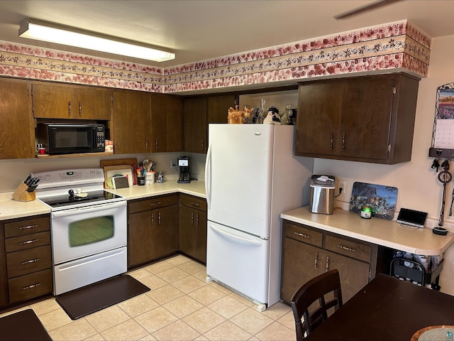 3824 Rehbein Rd, Duluth, MN 55803 - kitchen featuring light countertops, dark brown cabinetry, and white appliances
