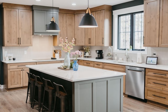 kitchen with a center island, light wood-type flooring, black electric cooktop, a sink, and dishwasher
