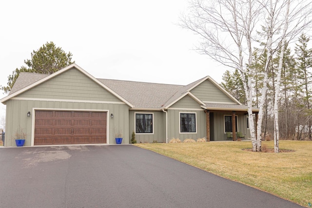 ranch-style home with a garage, a front yard, roof with shingles, board and batten siding, and driveway