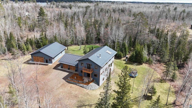 birds eye view of property with a wooded view