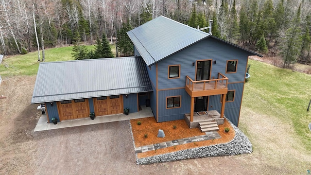 rustic home with a forest view, a front yard, and metal roof