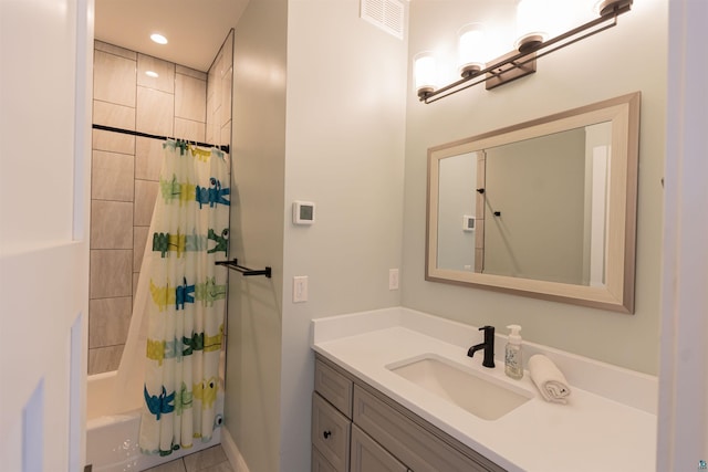 bathroom with shower / tub combo, vanity, recessed lighting, and visible vents